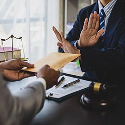 Attorney refusing envelope during fraud crime case consultation in Colorado or California