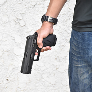 Person holding a black handgun; legal defense for firearm violations and gun rights in CA and CO.