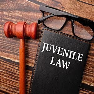 Judge's gavel and a legal notebook for juvenile law defense and youth justice representation.